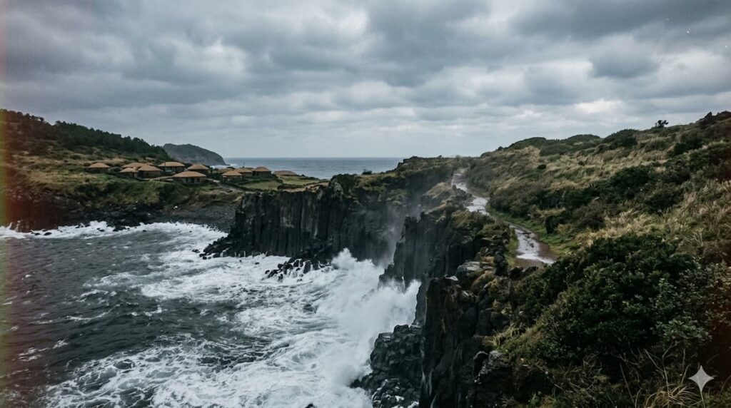 Paisaje épico de la costa de la isla de Jeju con acantilados volcánicos oscuros, un océano embravecido rompiendo contra las rocas, bajo un cielo gris difuso y casas tradicionales de piedra en la colina.